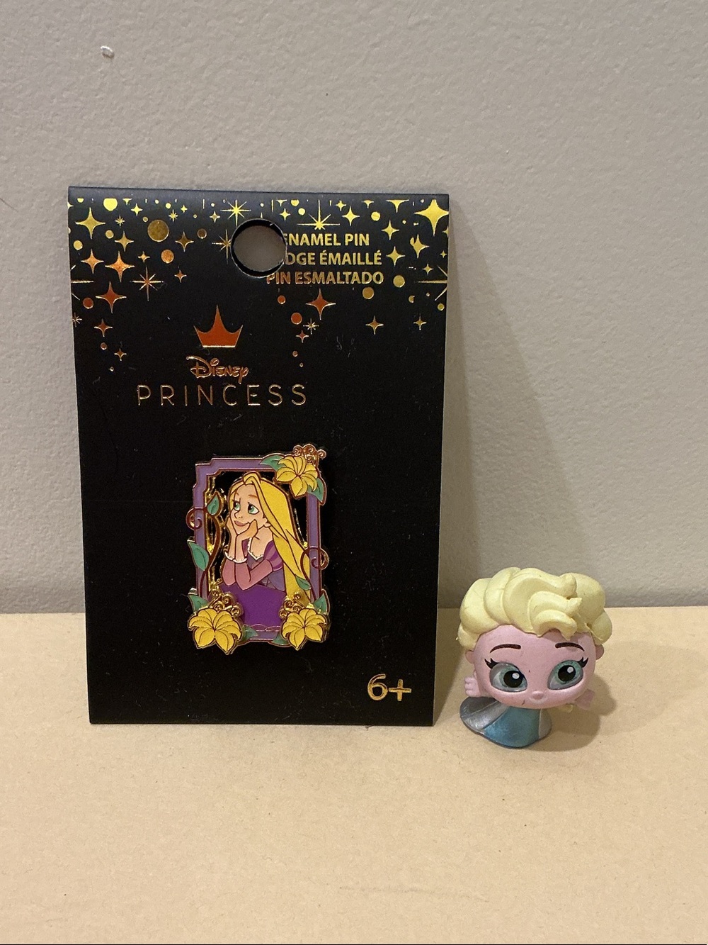 Princess Rapunzel collectible pin and Elsa doorable